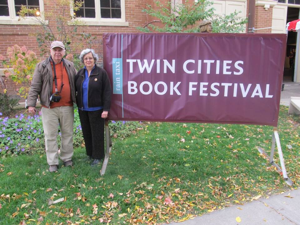 Karen and Clinton inf front of Twin Cities Book Festival banner